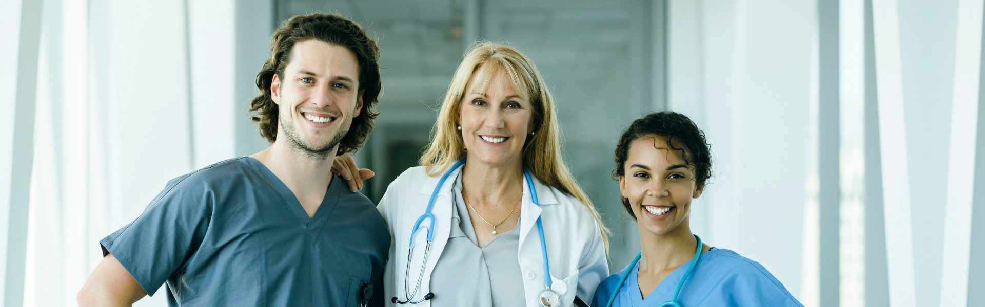 three medical professionals smiling